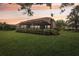 Landscaped backyard featuring a screened-in lanai and lush greenery, perfect for outdoor enjoyment at 431 Fieldstone Dr, Venice, FL 34292
