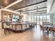 This is a view of the bar with wood floors, and multiple seating options with an attached outdoor patio at 431 Fieldstone Dr, Venice, FL 34292
