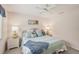 Bright bedroom offers wicker furniture, a ceiling fan, and a large window at 431 Fieldstone Dr, Venice, FL 34292