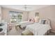 Cozy bedroom features two twin beds, a window seat, and soothing pink walls at 431 Fieldstone Dr, Venice, FL 34292