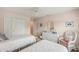 Comfortable bedroom features two twin beds, white dresser, and closet with sliding doors at 431 Fieldstone Dr, Venice, FL 34292
