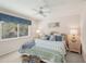Cozy bedroom with ceiling fan, wicker furniture, and a window with bright natural light at 431 Fieldstone Dr, Venice, FL 34292