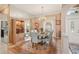 A formal dining area features an elegant chandelier, mirrored wall, and access to the front entry at 431 Fieldstone Dr, Venice, FL 34292