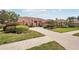Beautiful single-story home with a terracotta roof, mature landscaping, and brick driveway at 431 Fieldstone Dr, Venice, FL 34292