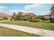A charming single-story home with lush landscaping and a terracotta roof at 431 Fieldstone Dr, Venice, FL 34292