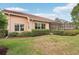 Beautiful home exterior with manicured lawn, tiled roof and screened in porch at 431 Fieldstone Dr, Venice, FL 34292