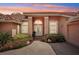 Charming home's front entrance with double doors, brick walkway, and evening sky at 431 Fieldstone Dr, Venice, FL 34292