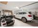 Spacious two-car garage featuring golf cart, white car, and ample storage space at 431 Fieldstone Dr, Venice, FL 34292