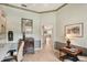 Cozy home office with traditional styled desk and cabinets and neutral colored carpet at 431 Fieldstone Dr, Venice, FL 34292