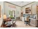 Home office with a built-in desk, storage shelves, large window and cozy decor at 431 Fieldstone Dr, Venice, FL 34292