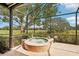 Relaxing hot tub overlooking golf course with lush landscaping and screened enclosure at 431 Fieldstone Dr, Venice, FL 34292