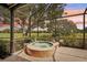 Relaxing hot tub overlooking golf course with lush landscaping and screened enclosure at 431 Fieldstone Dr, Venice, FL 34292