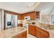 This updated kitchen features granite countertops, stainless steel appliances, and wood cabinets at 431 Fieldstone Dr, Venice, FL 34292