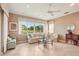 Open living room featuring large windows providing a view of the lush green landscape at 431 Fieldstone Dr, Venice, FL 34292