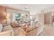 Open living area with tile floors, stylish sofas, and large windows showcasing the outdoor space at 431 Fieldstone Dr, Venice, FL 34292