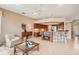 Cozy living room with a view into the kitchen, featuring tile flooring and warm color tones at 431 Fieldstone Dr, Venice, FL 34292