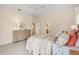 This well-lit main bedroom offers a dresser and access to a walk-in closet and ensuite bathroom at 431 Fieldstone Dr, Venice, FL 34292