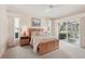 Main bedroom featuring a wood bed frame, neutral walls, and a sliding glass door to the outside at 431 Fieldstone Dr, Venice, FL 34292