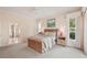 Well lit main bedroom featuring a view of the ensuite bathroom and neutral colored walls at 431 Fieldstone Dr, Venice, FL 34292