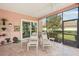 Relaxing screened-in patio with lounge chairs and views of the landscaped yard at 431 Fieldstone Dr, Venice, FL 34292