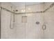 Close-up of shower boasting stylish tile accents, a built-in niche, and sleek fixtures at 431 Fieldstone Dr, Venice, FL 34292