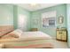 Cozy bedroom with a light-green wall, ceiling fan, and window at 4322 Reflections Pkwy, Sarasota, FL 34233