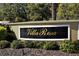 Elegant community sign for Villa Rosa, set amongst lush landscaping at 4322 Reflections Pkwy, Sarasota, FL 34233