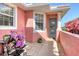 Inviting front entrance with a decorative wreath, vibrant flowers, and a charming seating area at 4322 Reflections Pkwy, Sarasota, FL 34233
