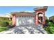 Attractive single-Gathering home showcasing a well-manicured lawn, lush landscaping, and a convenient two-car garage at 4322 Reflections Pkwy, Sarasota, FL 34233