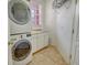 Convenient laundry room with stacked washer/dryer and ample cabinet space at 4322 Reflections Pkwy, Sarasota, FL 34233