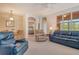 Cozy living area featuring comfortable sofas, a ceiling fan, and an open view to the dining area and bedroom at 4322 Reflections Pkwy, Sarasota, FL 34233