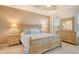 Inviting main bedroom with natural wood furniture and soft, patterned bedding at 4322 Reflections Pkwy, Sarasota, FL 34233