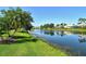 Picturesque pond view with manicured lawn and waterfront community at 4322 Reflections Pkwy, Sarasota, FL 34233