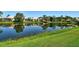 Scenic pond view surrounded by well-maintained landscaping and neighborhood homes at 4322 Reflections Pkwy, Sarasota, FL 34233
