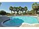 Community pool surrounded by lush landscaping and palm trees creates a relaxing resort-style ambiance at 4322 Reflections Pkwy, Sarasota, FL 34233