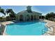 Community pool and clubhouse with ample seating around the pool deck at 4322 Reflections Pkwy, Sarasota, FL 34233