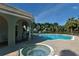 Community pool and hot tub with ample seating, shaded pavilion, and lush tropical landscaping at 4322 Reflections Pkwy, Sarasota, FL 34233