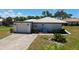 Aerial view of a well-maintained home with attached garage, surrounded by lush landscaping at 445 Matisse S Cir # 445, Nokomis, FL 34275
