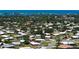 Wide aerial view shows home among trees, other residences, with water in the background at 445 Matisse S Cir # 445, Nokomis, FL 34275