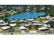 Aerial view of a home near a lake surrounded by lush greenery and other homes at 445 Matisse S Cir # 445, Nokomis, FL 34275