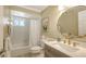 Updated bathroom with gold fixtures, decorative mirror, shower and tub combination at 445 Matisse S Cir # 445, Nokomis, FL 34275