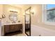 Bright bathroom featuring an updated vanity, hardwood floors, and modern lighting at 445 Matisse S Cir # 445, Nokomis, FL 34275