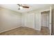 This is a cozy bedroom featuring wood-look flooring and closet space with modern ceiling fan at 445 Matisse S Cir # 445, Nokomis, FL 34275