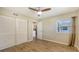 This bright bedroom features wood-look floors, a window, and built in closet space at 445 Matisse S Cir # 445, Nokomis, FL 34275