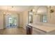 Bright dining room featuring a bar area, modern light fixture, and view of the outdoor space at 445 Matisse S Cir # 445, Nokomis, FL 34275