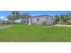 Well-maintained single-story home with lush green lawn, manicured landscaping, and attached garage at 445 Matisse S Cir # 445, Nokomis, FL 34275