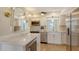 Bright kitchen featuring stainless steel appliances, white cabinetry, quartz countertops and modern lighting fixtures at 445 Matisse S Cir # 445, Nokomis, FL 34275