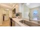 Bright kitchen featuring stainless steel appliances, quartz countertops, and easy access to the laundry room at 445 Matisse S Cir # 445, Nokomis, FL 34275