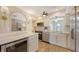 Bright kitchen featuring stainless steel appliances, white cabinetry, quartz countertops and modern lighting fixtures at 445 Matisse S Cir # 445, Nokomis, FL 34275