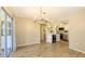 Bright, open kitchen with stainless steel appliances and breakfast bar is connected to dining room with chandelier at 445 Matisse S Cir # 445, Nokomis, FL 34275